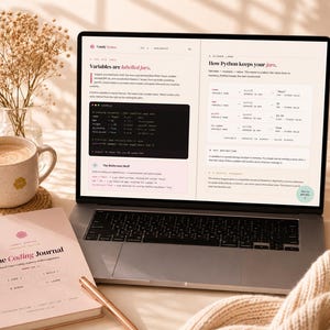 May include: A laptop displaying a digital page titled Comfy Syntax with text about Python variables, alongside a spiral-bound notebook titled The Coding Journal, a ceramic mug, a pen, and a vase of dried flowers on a light-colored surface.