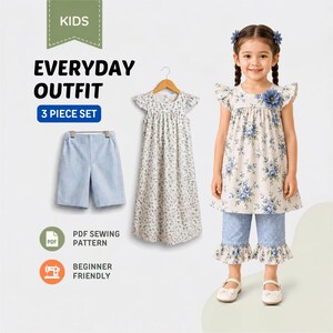 May include: A three-piece kids' outfit set featuring a floral tunic with a blue flower accent, ruffled cap sleeves, and matching blue floral cropped pants with ruffled hems. Includes a plain light blue pair of shorts and a sewing pattern.
