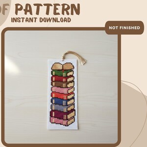 May include: A cross-stitch bookmark pattern featuring a vertical stack of eight colorful books in shades of green, red, brown, pink, blue, and purple. The PDF pattern includes the text PDF PATTERN, INSTANT DOWNLOAD, and NOT FINISHED.