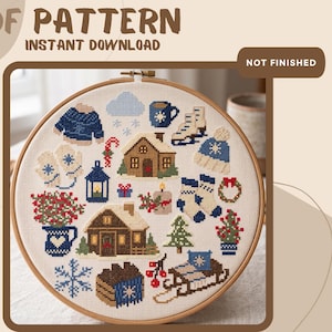 May include: A cross-stitch pattern in a wooden embroidery hoop featuring winter-themed icons including two cabins, a sled, ice skates, a blue sweater, mittens, a mug, a candle, a wreath, a pine tree, snowflakes, and a pitcher with red berries.