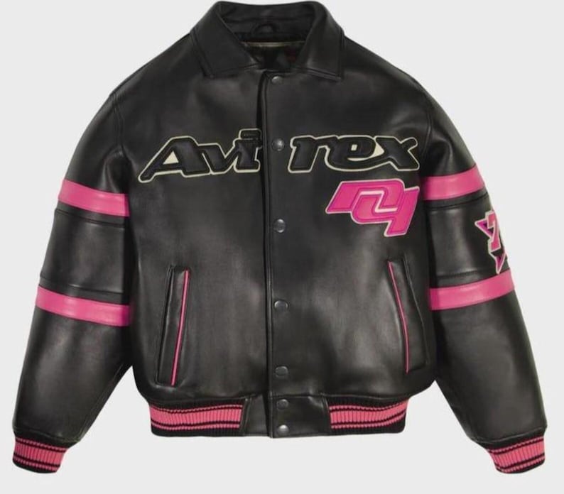 May include: A black leather varsity jacket featuring the text Avirex in white and black lettering across the chest. The jacket includes bright pink horizontal stripes on the sleeves, a pink graphic on the chest, and pink ribbed cuffs and hem.