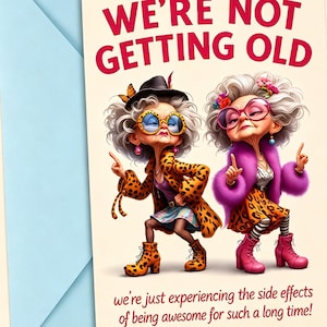 May include: A greeting card with the text WE'RE NOT GETTING OLD and we're just experiencing the side effects of being awesome for such a long time. Two elderly characters with grey hair, leopard print clothing, and colourful glasses are posing.