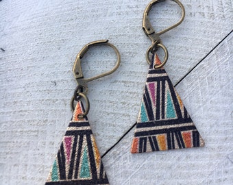 May include: A pair of triangle-shaped earrings with a geometric pattern in black, orange, pink, and turquoise on a gold background. The earrings have bronze-colored hooks.