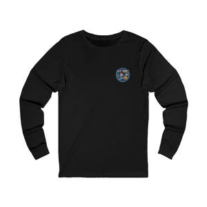 May include: Black long-sleeve shirt with a small circular graphic on the upper left chest. The graphic features the text "GIT FUNNY" in a blue and white design with cartoon characters. The shirt has a crew neck and long sleeves.