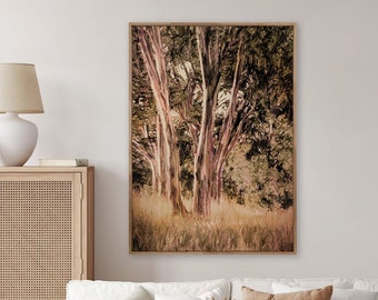 May include: A framed print of a forest scene with tall trees and a soft, muted color palette. The trees are a light brown with hints of pink and green. The background is a soft green and brown.