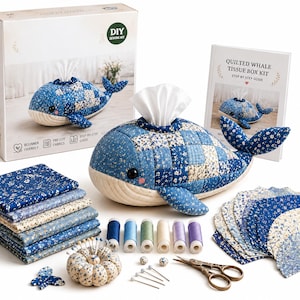 May include: A DIY sewing kit for a quilted whale tissue box, including a finished whale-shaped tissue cover, stacks of blue and cream floral fabric squares, five spools of thread, a pincushion, sewing pins, and a step-by-step guide book.