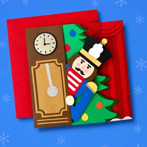 May include: A layered paper greeting card featuring a brown grandfather clock, a nutcracker figure in a black, red, and blue uniform, and a green Christmas tree with colorful ornaments. The card is set against a red background with a red envelope.