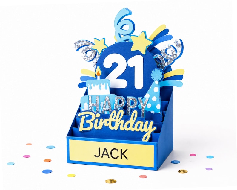 May include: A blue 3D pop-up birthday card featuring the number 21 in white, a cake, a party hat, and stars. The card displays the text HAPPY BIRTHDAY and the name JACK on a yellow rectangular base, accented with silver holographic details.