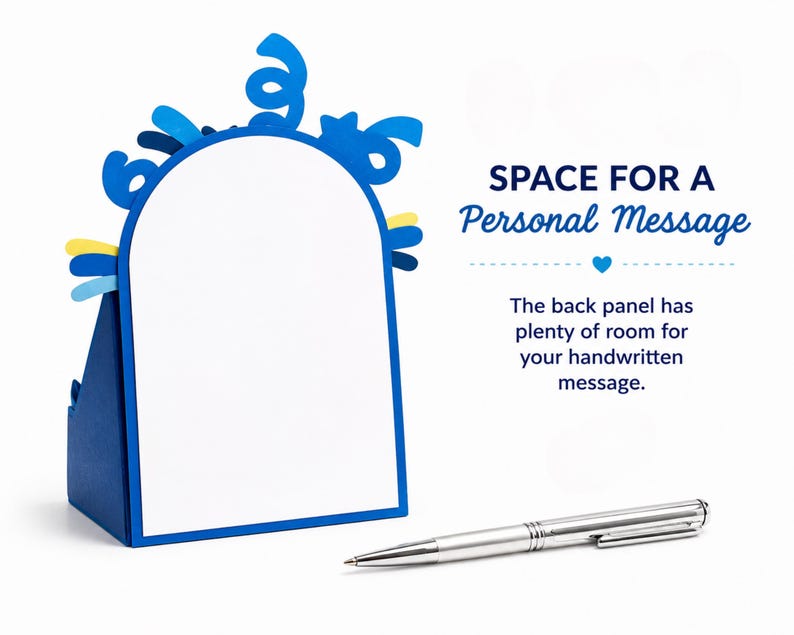 May include: A blue arched card with a white center panel and blue confetti-like cutouts at the top. The text reads: SPACE FOR A PERSONAL MESSAGE. The back panel has plenty of room for your handwritten message. A silver ballpoint pen lies in front.