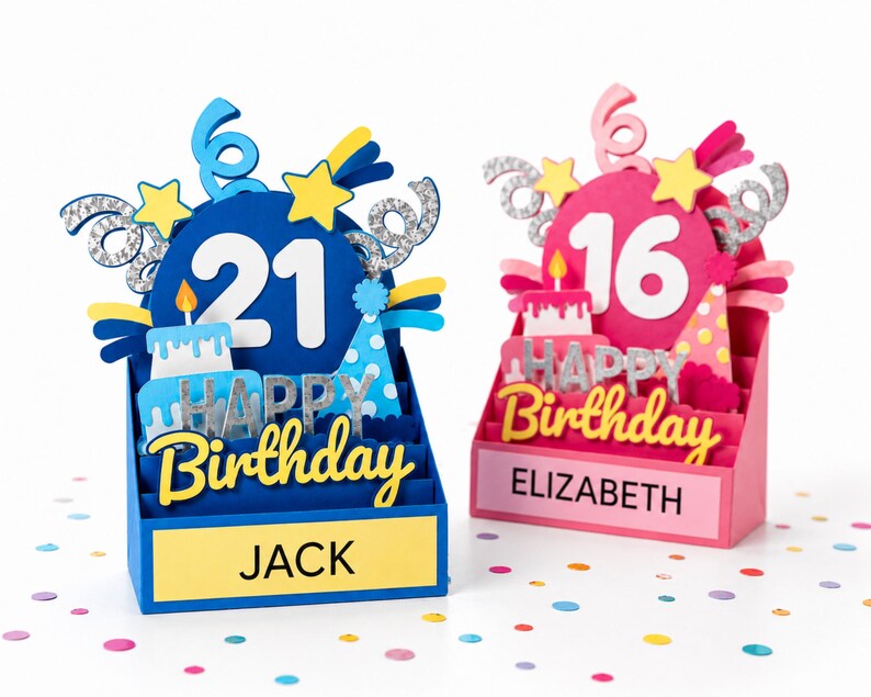May include: Two 3D pop-up birthday cards. The blue card features the number 21, a cake, a party hat, and the name JACK. The pink card features the number 16, a cake, a party hat, and the name ELIZABETH. Both cards display the text HAPPY BIRTHDAY.