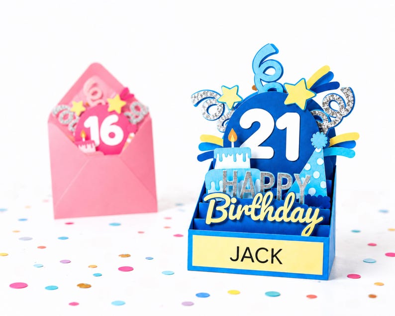 May include: A blue 3D pop-up birthday card featuring the number 21, a cake, a party hat, and the text "HAPPY Birthday" and "JACK" on a yellow base, with a pink envelope containing a card with the number 16 in the background.