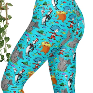 May include: High-waisted leggings in a bright turquoise blue featuring an all-over print of Dr. Seuss characters including the Cat in the Hat, the Lorax, Thing 1 and Thing 2, and Horton the elephant, interspersed with small colorful fish and green eggs.