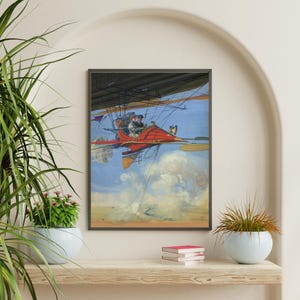 May include: A framed vintage print depicts a red aircraft with passengers soaring through a blue sky filled with clouds. The aircraft has a propeller and a large, black canopy. The artwork is a colorful illustration.