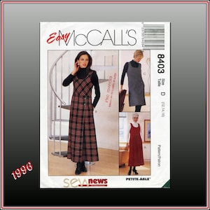 May include: McCall's sewing pattern featuring a plaid jumper dress with button details. The pattern includes multiple views and sizes. The image shows a woman wearing the dress. The pattern is from 1996.