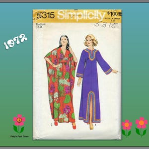 May include: Simplicity sewing pattern 5315 from 1972. The pattern features two long dresses. One is a red, orange, and green floral print. The other is a solid purple dress with gold trim. The pattern is for a medium size 12-14.