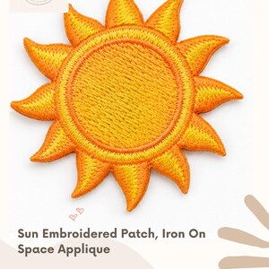May include: A circular sun embroidered patch featuring a bright yellow center and orange rays. The patch measures 1-7/8 inches by 1-7/8 inches and is designed for iron-on application. The text reads Sun Embroidered Patch, Iron On Space Applique.