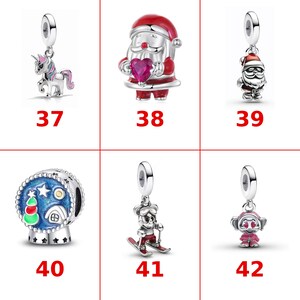 May include: A collection of six silver charms labeled 37 through 42. The charms feature a unicorn, a Santa Claus holding a red heart, a small Santa Claus, a blue snow globe with a tree and house, a skier, and a pink character with heart eyes.