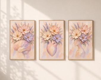 May include: A set of three framed wall art prints featuring textured, pastel-colored floral arrangements. The first print depicts a human brain, the second an anatomical heart, and the third a human profile, all topped with blooming flowers.