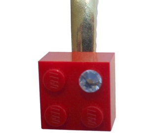 Red LEGO® brick 2x2 with a ‘Diamond’ color SWAROVSKI® crystal on a Silver/Gold hair clip (one piece)