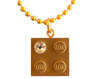 Metallic Gold LEGO® brick 2x2 with a ‘Diamond’ color SWAROVSKI® crystal on a 24" Gold plated ballchain