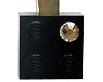 Black LEGO® brick 2x2 with a ‘Diamond’ color SWAROVSKI® crystal on a Silver/Gold hair clip (one piece)