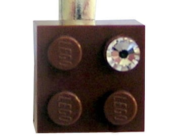 Brown LEGO® brick 2x2 with a ‘Diamond’ color SWAROVSKI® crystal on a Silver/Gold hair clip (one piece)