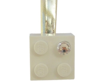 White LEGO® brick 2x2 with a ‘Diamond’ color SWAROVSKI® crystal on a Silver/Gold hair clip (one piece)