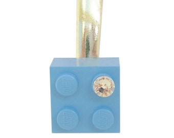 Light Blue LEGO® brick 2x2 with a ‘Diamond’ color SWAROVSKI® crystal on a Silver/Gold hair clip (one piece)