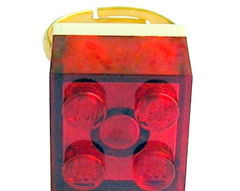 Transparent Red LEGO® brick 2x2 on a Silver/Gold plated adjustable ring finding