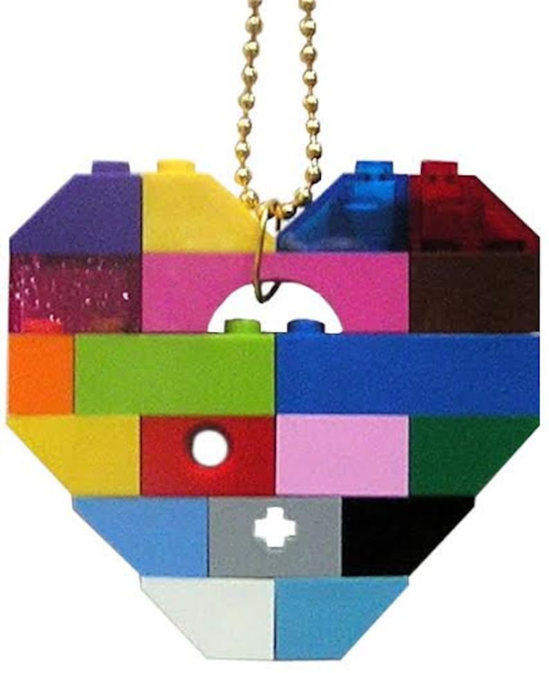 May include: A heart-shaped ornament made of colorful Lego bricks, with a gold chain attached to the top.