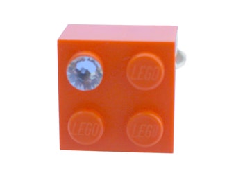 Orange LEGO® brick 2x2 with a ‘Diamond’ color SWAROVSKI® crystal on a Silver/Gold plated adjustable ring finding*
