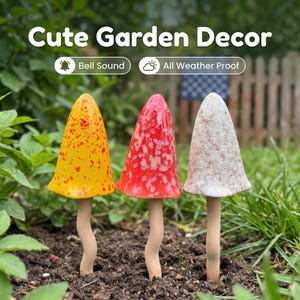 May include: Three ceramic mushroom garden stakes with speckled caps in yellow, red, and white. The text "Cute Garden Decor" appears above, with labels "Bell Sound" and "All Weather Proof". Each mushroom has a slender, wavy beige stem.