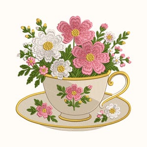 May include: An embroidery design featuring a cream-colored teacup and saucer with gold trim, decorated with a pink floral motif. The cup is filled with a vibrant bouquet of embroidered pink and white cosmos flowers, green leaves, and small buds.