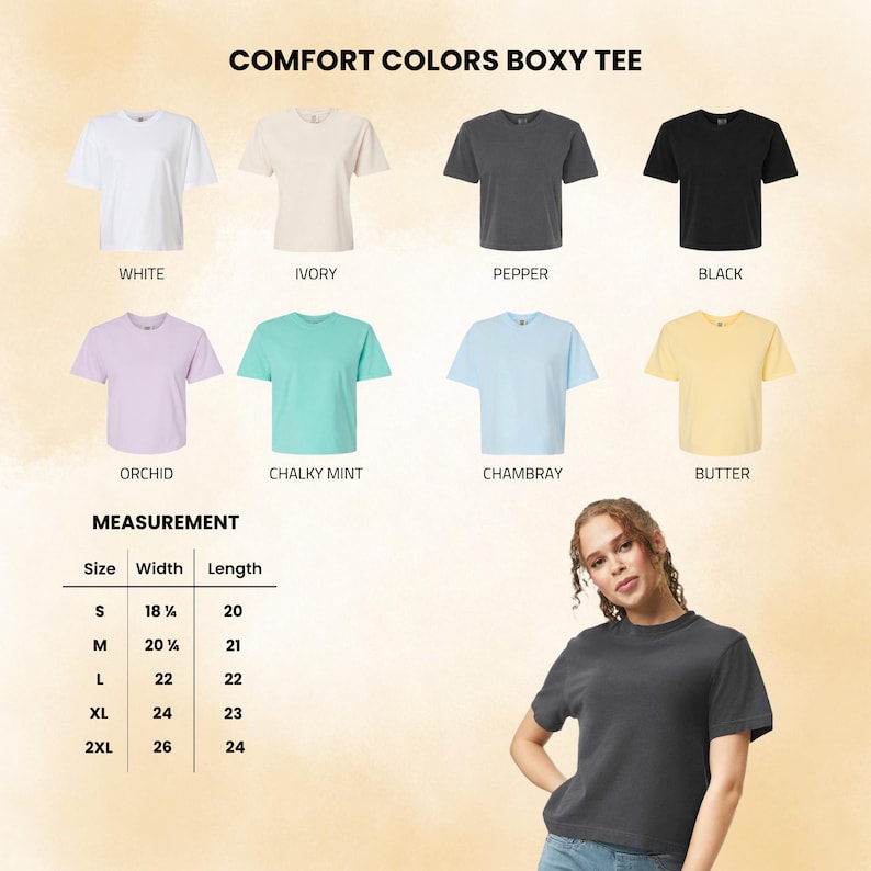 May include: A collection of Comfort Colors boxy t-shirts in white, ivory, pepper, black, orchid, chalky mint, chambray, and butter. A measurement chart lists widths and lengths in inches for sizes S through 2XL. A person wears a pepper-colored tee.