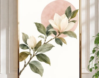 Peut inclure: Une impression d'art encadrée représentant une illustration à l'aquarelle d'une branche de magnolia avec deux fleurs crème et des feuilles vertes sur un fond circulaire rose pâle, le tout dans un cadre fin de couleur dorée.