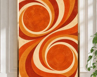 Peut inclure: Une impression d'art mural rectangulaire présentant deux grands motifs circulaires tourbillonnants dans des tons orange brûlé, rouge profond et crème. Le design se compose de lignes courbes rayonnantes encadrées par un fin cadre doré.