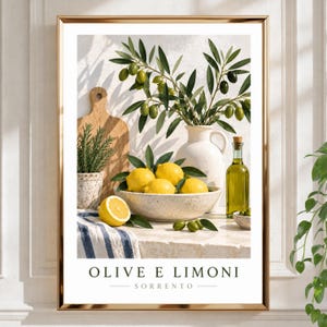 May include: A framed wall art print featuring a bowl of yellow lemons, a white ceramic pitcher with olive branches, a wooden cutting board, a glass bottle of olive oil, and a blue and white striped cloth, with the text OLIVE E LIMONI SORRENTO.