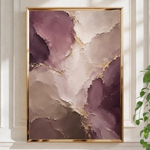 May include: A rectangular wall art piece featuring thick, textured impasto paint in shades of deep plum, mauve, and beige. The composition includes abstract, flowing layers separated by thin, shimmering gold leaf accents, all encased in a thin gold frame.