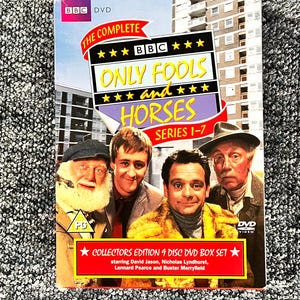 May include: The Complete BBC Only Fools and Horses Series 1-7 DVD box set featuring four men on the cover. The title is printed in yellow and white text on a black background. A red banner at the bottom reads Collectors Edition 9 Disc DVD Box Set.