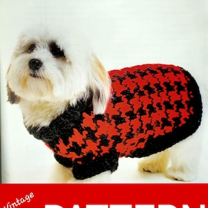 May include: A vintage dog sweater knitting pattern from 1999. The pattern features a houndstooth design in red and black. The text "HOUNDS-TOOTH" and "It's a dog's life" are printed above the image. The text "Vintage '99 PATTERN" is printed below the image.