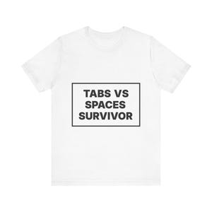 May include: A white short-sleeved t-shirt featuring a black rectangular outline centred on the chest. Inside the rectangle, the text TABS VS SPACES SURVIVOR is printed in bold, black, sans-serif capital letters, creating a clear graphic design.