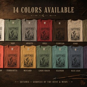 May include: A display of 14 different colored t-shirts, each folded and featuring the word "ARTEMIS" above a graphic of a woman with a bow and arrow. The available colors include white, sage, granite, chili, espresso, ivory, khaki, bright salmon, terracotta, mustard, light green, seafoam, blue jean, and grape.