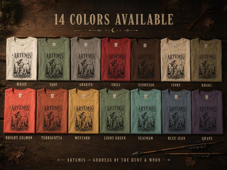 May include: A display of 14 different colored t-shirts, each folded and featuring the word "ARTEMIS" above a graphic of a woman with a bow and arrow. The available colors include white, sage, granite, chili, espresso, ivory, khaki, bright salmon, terracotta, mustard, light green, seafoam, blue jean, and grape.