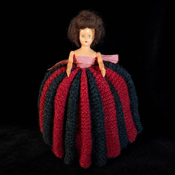 A hand-knitted vintage doll tea cosy that is genuinely unsettling in the best possible way — functional kitchenware that doubles as a gothic curiosity and instant conversation piece.
