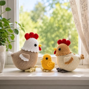 May include: Three crocheted chicken figures including a large tan and white hen with a red comb, a small yellow chick, and a medium-sized tan and cream hen with a red comb. Each figure features black bead eyes and textured yarn construction.