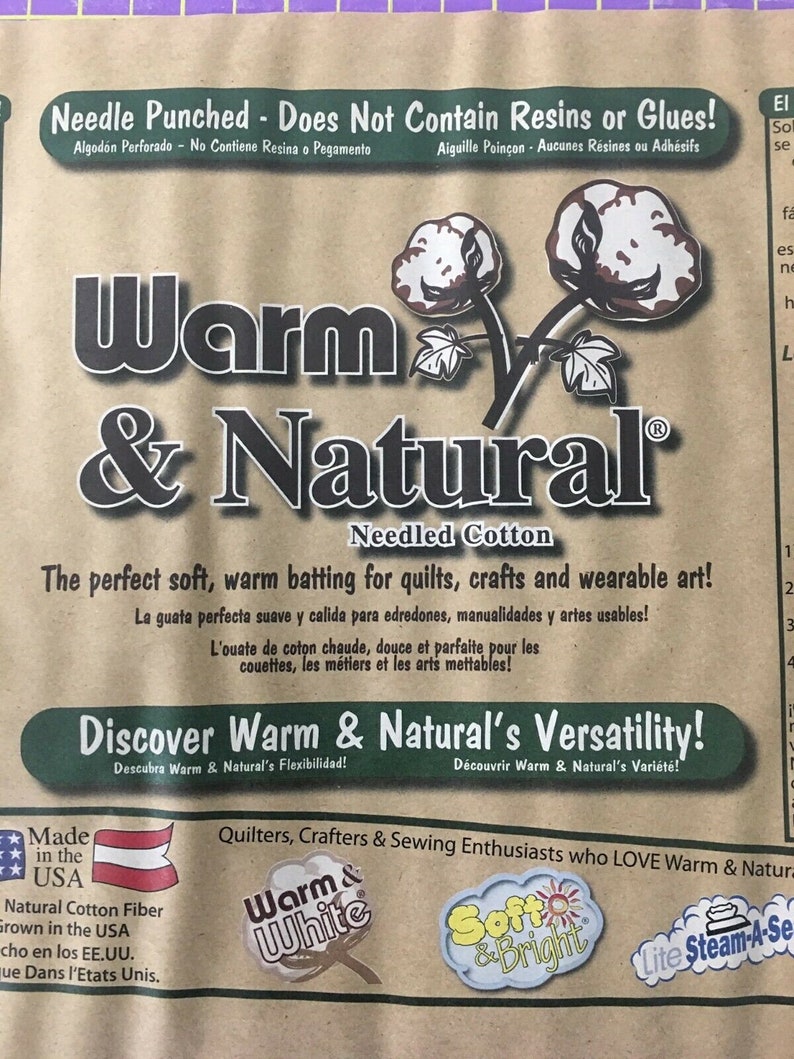 May include: A brown paper bag with the text "Warm & Natural" in large black letters. The bag is advertising needled cotton batting for quilts, crafts, and wearable art. The text "Discover Warm & Natural's Versatility!" is printed in a green box. The bag also features a small American flag and the text "Made in the USA".