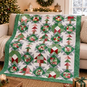 May include: A patchwork quilt featuring a repeating pattern of Christmas trees and geometric blocks in shades of green, red, white, and gray. The quilt has a solid green border and is constructed from various patterned fabric squares.