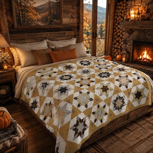 May include: A quilt featuring a repeating star pattern in shades of mustard yellow, white, gray, and dark brown. The textile displays a geometric arrangement of eight-pointed stars set against a mustard yellow background with white diamond accents.