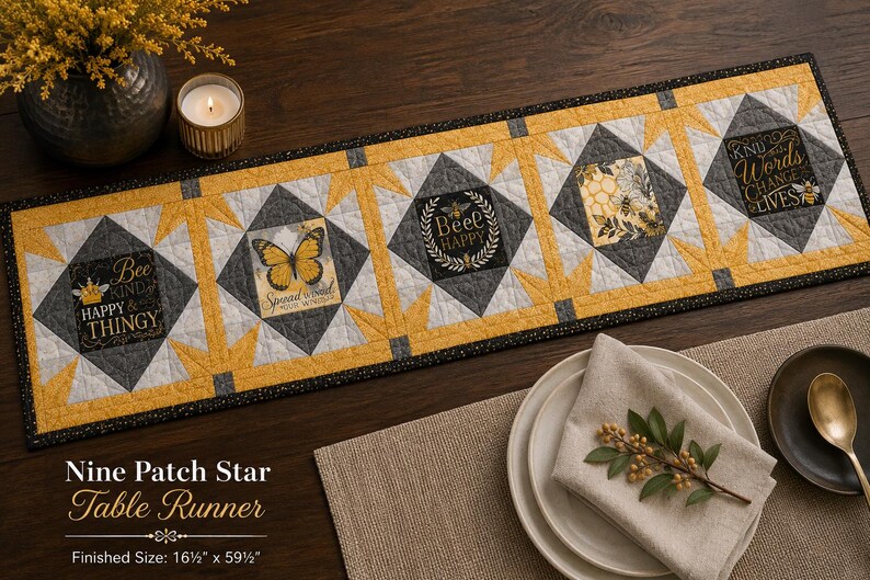 May include: A rectangular quilted table runner featuring a Nine Patch Star pattern in yellow, gray, and white. The fabric panels display bee-themed graphics and text including Bee Kind, Spread Your Wings, Bee Happy, and Kind Words Change Lives.