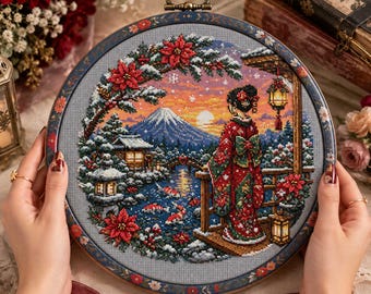 May include: A circular cross-stitch embroidery piece featuring a winter landscape with a snow-covered mountain, a bridge, and a pond with koi fish. A figure in a red patterned kimono stands on a wooden deck, framed by poinsettias and a lantern.